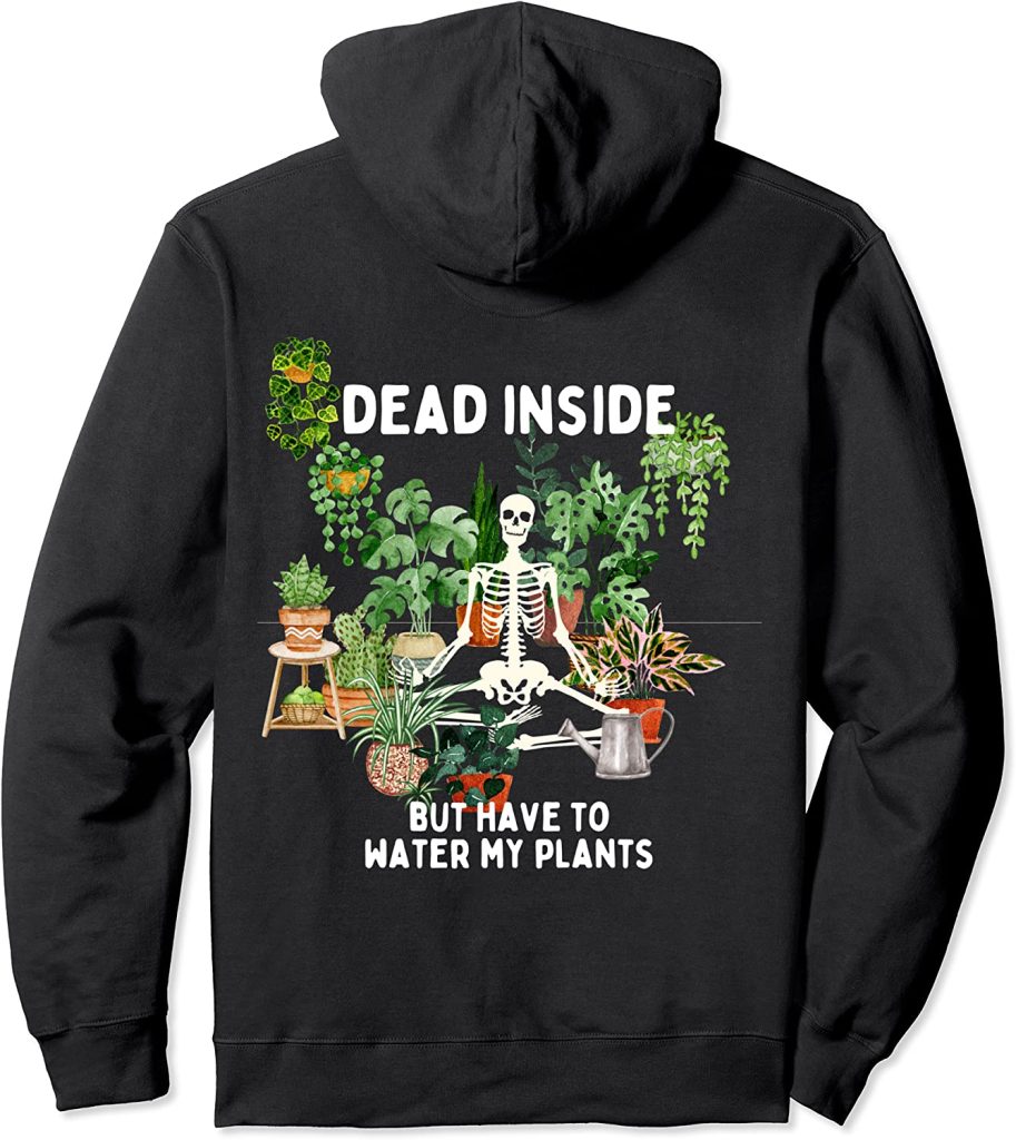 Sweatshirt that has a skeleton surrounded by plants that says "dead inside but i need to water my plants"